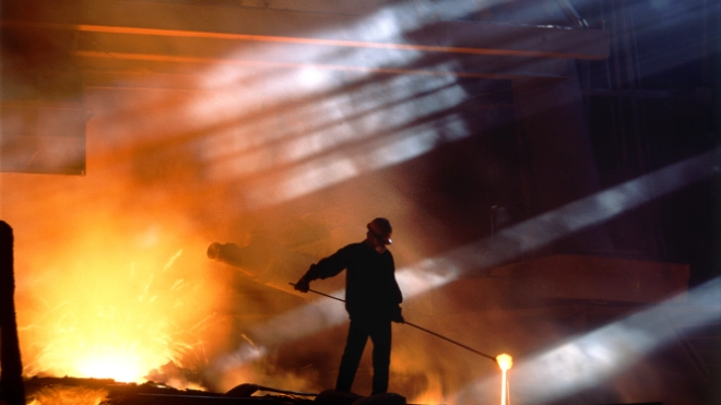 Smelting worker moving ore in landscape shot